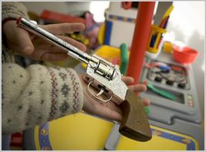 Child Holding a Toy Gun